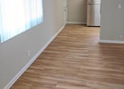 Thumbnail 26 of 42 - A room with a ceiling fan and wooden flooring.