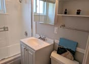 Thumbnail 13 of 63 - A small white bathroom with a white sink and toilet.