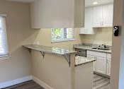 Thumbnail 10 of 43 - A kitchen with a countertop and cabinets.
