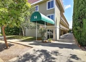 Thumbnail 2 of 51 - a building with a green canopy in front of it