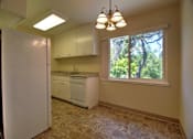 Thumbnail 14 of 20 - A kitchen with a refrigerator, sink, and cabinets.