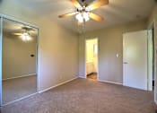 Thumbnail 18 of 20 - A room with a ceiling fan and a light fixture.