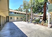 Thumbnail 6 of 20 - A concrete courtyard surrounded by apartment buildings.