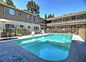 Thumbnail 8 of 20 - A swimming pool in a residential area surrounded by a fence.