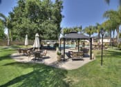 Thumbnail 7 of 35 - grass space and chairs with umbrellas at The Arbors at Mountain View, Mountain View, 94040