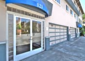 Thumbnail 14 of 31 - the front door of a building with a large glass window and
