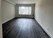 Thumbnail 12 of 32 - an empty room with wood floors and a window