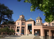 Thumbnail 20 of 21 - a large building with three towers in front of a blue sky