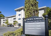 Thumbnail 1 of 11 - a large building with a sign in front of it