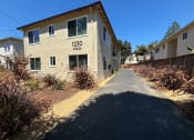 Thumbnail 9 of 19 - an apartment building with a sidewalk in front of it