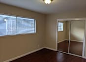 Thumbnail 33 of 36 - A room with a sliding glass door and a window with blinds.