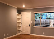 Thumbnail 27 of 47 - A room with wooden floors and a white door.