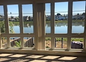Thumbnail 18 of 26 - a living room with windows overlooking a body of water