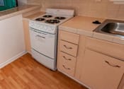 Thumbnail 22 of 25 - a small kitchen with a stove and a sink
