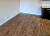 Thumbnail 6 of 11 - an empty living room with wooden floors and a ceiling fan