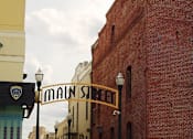 Thumbnail 18 of 32 - a street with a brick building and a sign for main street