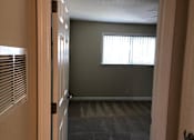 Thumbnail 33 of 62 - an empty room with a window and a door
