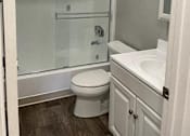 Thumbnail 33 of 33 - A white toilet sits next to a sink in a small bathroom.