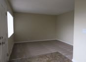Thumbnail 24 of 31 - an empty living room with a wood floor
