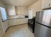 Thumbnail 14 of 19 - a kitchen with stainless steel appliances and white cabinets