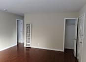 Thumbnail 30 of 36 - A room with wood floors and white walls.