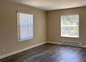 Thumbnail 34 of 36 - an empty living room with three windows