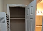 Thumbnail 25 of 42 - A white door is open to a room with a white sink.