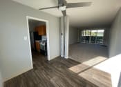 Thumbnail 22 of 31 - a living room and kitchen with a ceiling fan