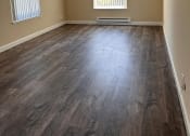 Thumbnail 25 of 36 - an empty room with wood floors and two windows