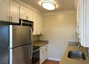 Thumbnail 28 of 62 - a kitchen with stainless steel appliances and white cabinets