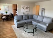 Thumbnail 20 of 32 - a living room with a couch and a glass coffee table