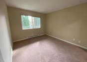 Thumbnail 43 of 51 - a large empty room with carpet and a window