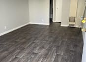 Thumbnail 20 of 33 - A room with a wood floor and a door on the right.