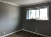 Thumbnail 29 of 43 - A room with a window and a striped carpet.