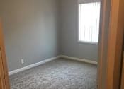 Thumbnail 27 of 31 - A room with a carpeted floor and a window.
