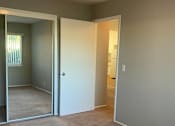 Thumbnail 16 of 37 - A room with a carpeted floor and a white door.