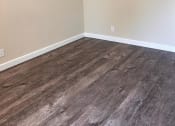 Thumbnail 35 of 36 - an empty room with wood floors and white walls