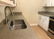 Thumbnail 43 of 62 - a kitchen with a sink and a wood floor