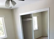Thumbnail 18 of 37 - A room with a carpeted floor and a ceiling fan.