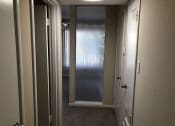 Thumbnail 20 of 31 - a hallway with a closet and a door