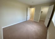 Thumbnail 26 of 51 - a bedroom with a carpeted floor and a door to a closet