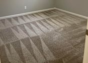 Thumbnail 15 of 22 - A room with a ceiling fan and carpeted floor.