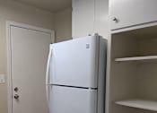 Thumbnail 42 of 42 - A white refrigerator in a kitchen with a white door.