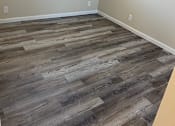 Thumbnail 9 of 43 - A room with a wooden floor and a window with blinds.