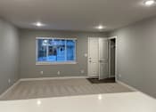 Thumbnail 8 of 19 - A room with a white floor and a window with blinds.