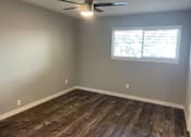 Thumbnail 10 of 19 - A room with a ceiling fan and a window with blinds.