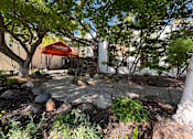 Thumbnail 17 of 19 - A tree-filled area with a tent and a sign that says "The Midtown".