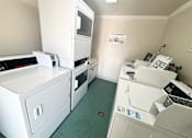 Thumbnail 11 of 23 - A clean, white-walled commercial kitchen with green floor tiles.