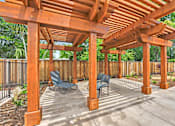 Thumbnail 12 of 44 - Outdoor shaded overhang with lounge chairs