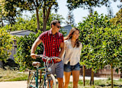 Thumbnail 10 of 101 - a man and a woman standing next to a bike